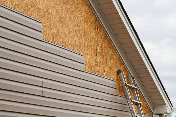 Professional Storm Damage Siding Repair technician working in Jordan, NY